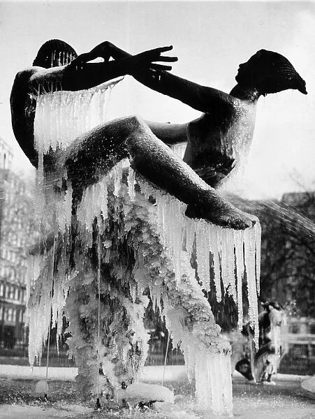 Ice Dance. circa 1936: Icicles hang from two dancing figures in a fountain in Hyde Park