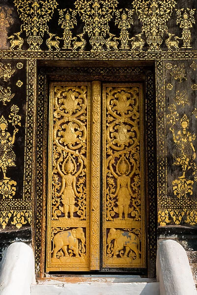 The Laotian golden gilded black lacquer art technique and wood carving at the door inside
