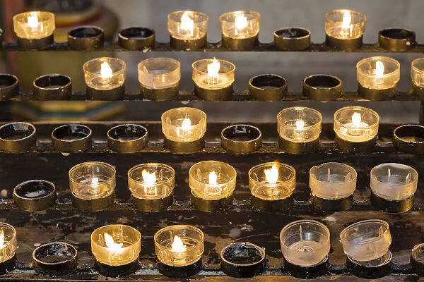 Lighted votive candles in a church, Munich, Upper Bavaria, Bavaria, Germany
