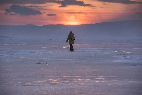 a man walking on a frozen lake Baikal