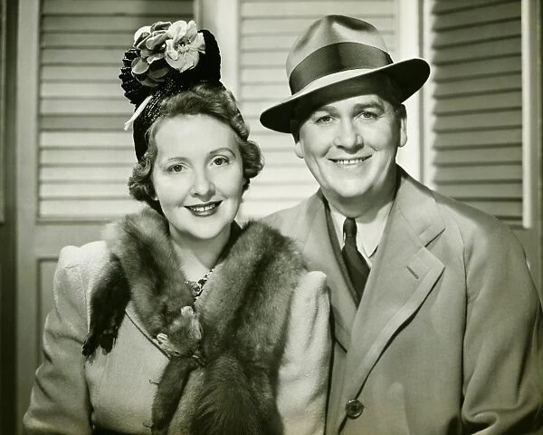 Mature couple posing dressed in outdoor clothing, (B&W), portrait