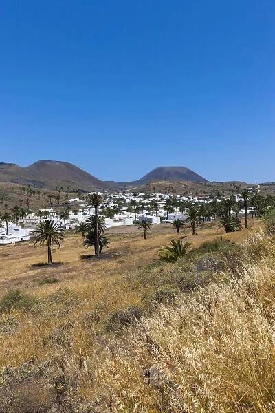 The mountain village of Haria, with its white houses, the volcano Monte Corona at the back, Maguez, Lanzarote, Canary Islands, Spain
