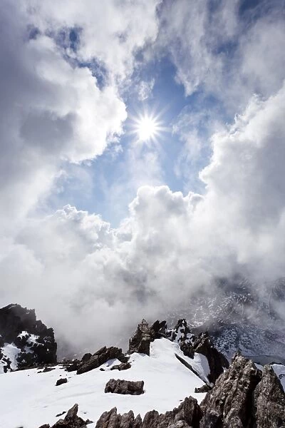 On the peak of Lorcherspitz mountain above lake Gruensee, low stratus, province of Bolzano-Bozen, Italy, Europe