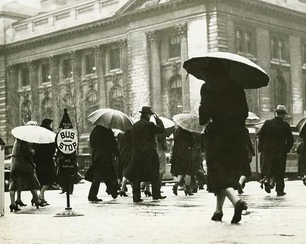 Pedestrians walking in rain in New York City, (B&W)