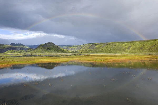 Rainbow over a small lake near Soelheimajoekulsvegur, Iceland