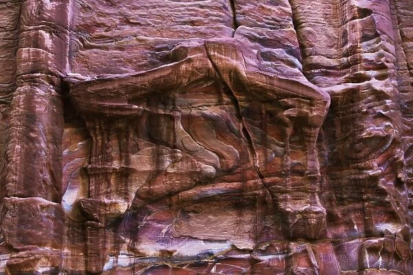 A rugged rock wall of colourful sandstone