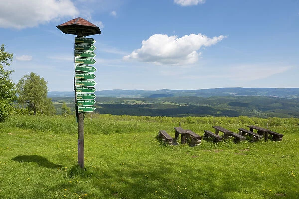 Signsposts, distance markers, wooden benches and tables on Mt Dolmar with views of the Thuringian Forest, Thuringia, Germany