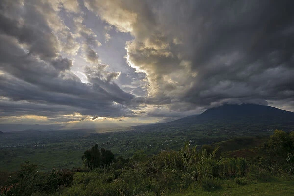 Sunset over the Virunga Mountains of the Volcanoes National Park in Rwanda with the rural settlements dotting the landscape