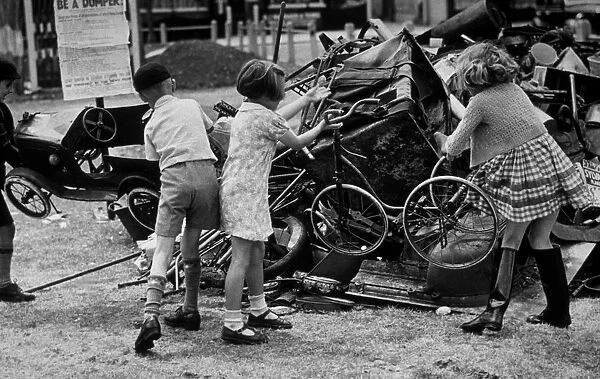 Toy Dump. 1940: Youngsters throw some of their old toys onto a scrap dump