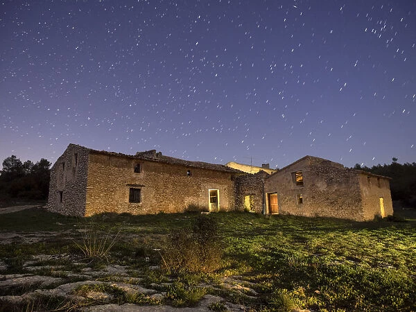 Uninhabited and derelict farmhouse blue night sky with stars