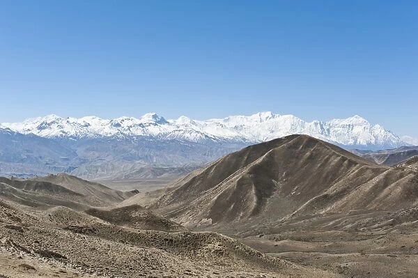 Vast landscape with the snow-covered mountains of the Annapurna Range at back, near Lo Manthang, Upper Mustang, Lo, Nepal
