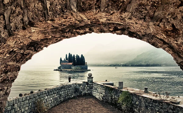 view of an island at perast on a foggy day