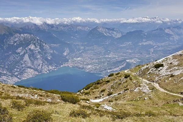 View of Lake Garda and Arco, on the way to the top of Monte Altissimo mountain above Nago-Torbole, province of Trentino, Italy, Europe