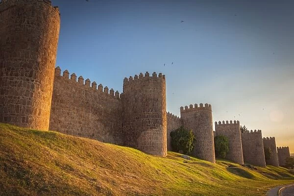 Walls of Avila at sunset. Fortified building. Fence surrounding the city