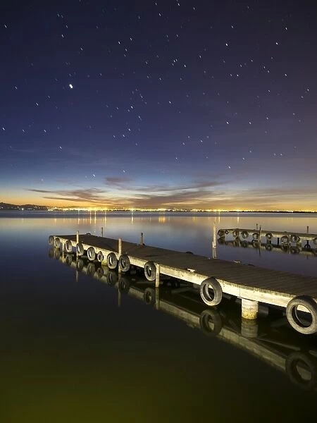 Wooden pier on a lake in the night