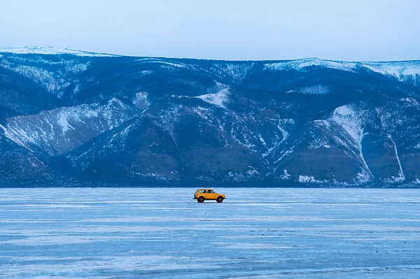 A yellow car on the frozen Baikal lake