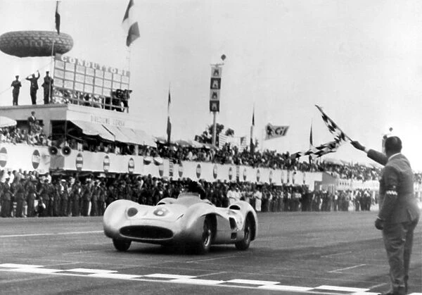 Argentines car ace Juan Manuel Fangio in a Mercedes Bez is flagged in winner of