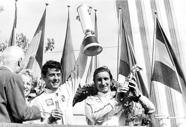 Monza, Italy: Brian Redman and Jo Siffert hold aloft their trophies after winning the 1, 000 KMS