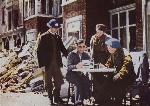 British air raid victim reporting damage his home to a civil defence incident officer, World War II, 1940-1945 (photo)