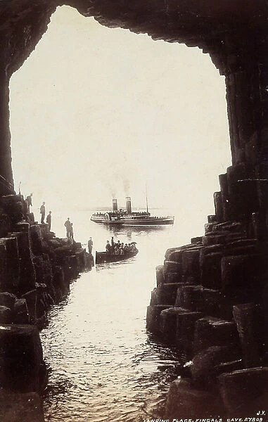 A group of people visiting the Fingal's Cave, on the Island of Staffa, in Scotland
