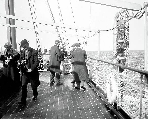 Italy, Sicily: crossing, life on the bridge of a liner with idle tourists taking the cool and chatting, tourists taking a souvenir photo on the bridge of the boat, 1890 - liner: island of France Marseille