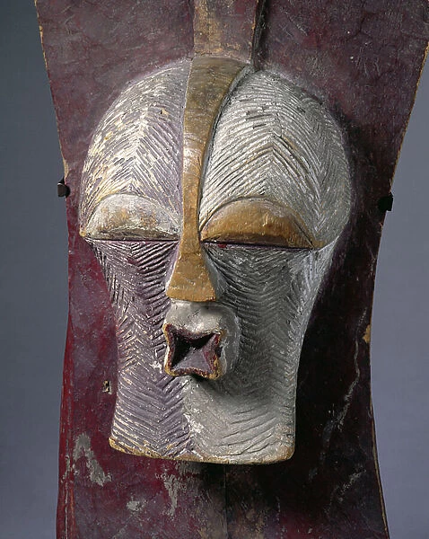 Kifwebe shield carved with a face with protruding mouth and incised with paralled zig-zag bands from the Songye tribe of Zaire, Africa, c.1893-1900 (polychrome wood)