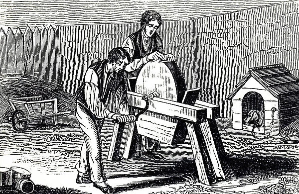 A man sharpening a blade on a grindstone