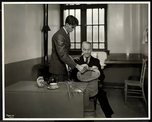 Man teaching another man basketmaking at the New York Association for the Blind