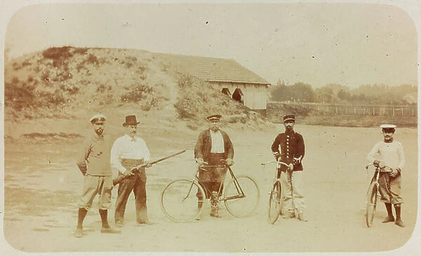 Portrait of a group of men posing with their bicycles in the countryside , Mont Saint Michel