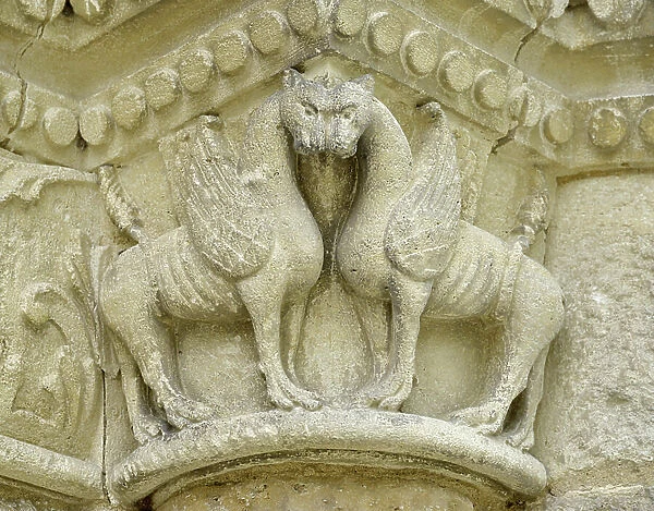 Romanesque art: marquee detail depicting monsters wings - Main facade of the church Notre Dame (Notre-Dame) of Surgeres (17700), Charente-Maritime
