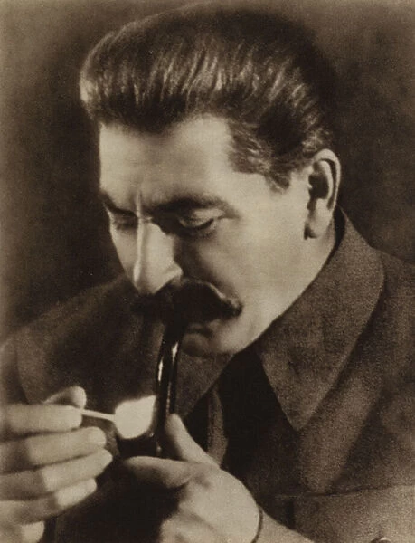 Soviet leader Joseph Stalin lighting his pipe, 1936 (b  /  w photo)