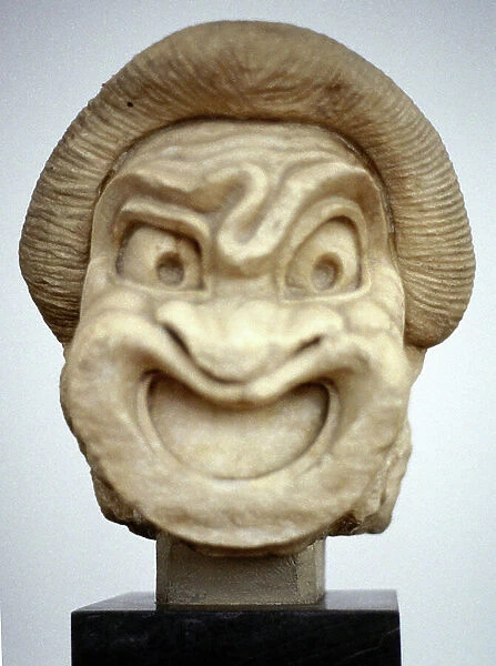 Stone carving of ancient Greek theatrical mask representing comedy. 3rd century BC (sculpture)