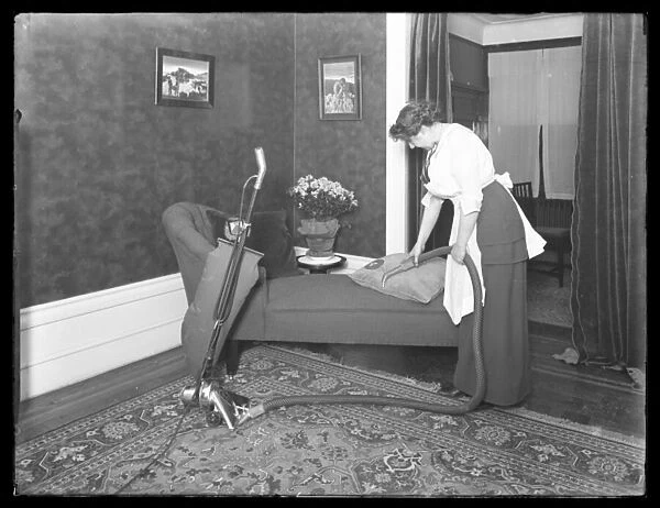 Unidentified woman demonstrating the use of the Apex vacuum cleaner