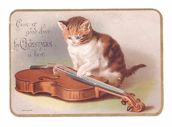 A Victorian Christmas card of a kitten with its paw on a guitar, c