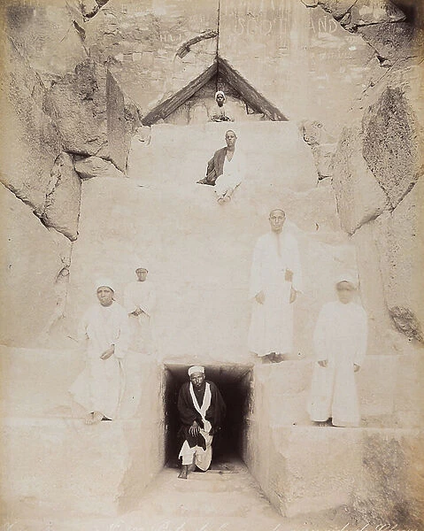 View of a group of Egyptians in traditional dress at the entrance of the Great Pyramid of Cheops. Cairo, El Giza, 1885 (print on double-weight paper)