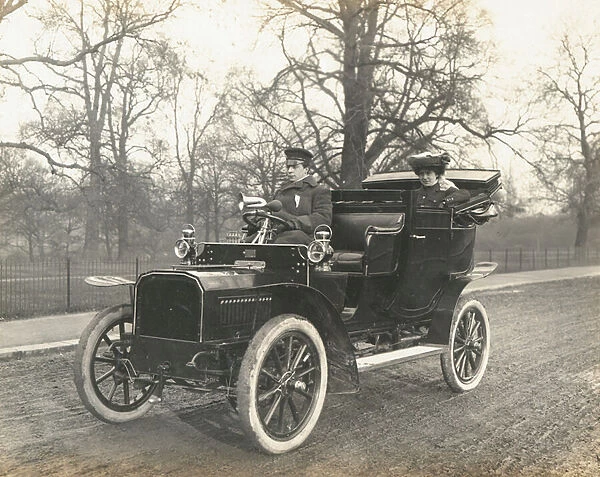 Woman and chauffeur in fine early automobile (b  /  w photo)