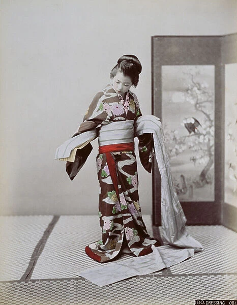Young Japanese Girl Dressing, late 19th century (hand coloured photo)