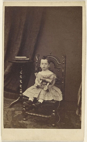 little girl holding toy wooden horse seated 1865
