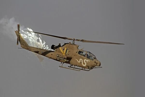An AH-1S Tzefa of the Israeli Air Force dispenses flares