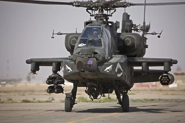 An AH-64 Apache helicopter returns from a mission over Iraq