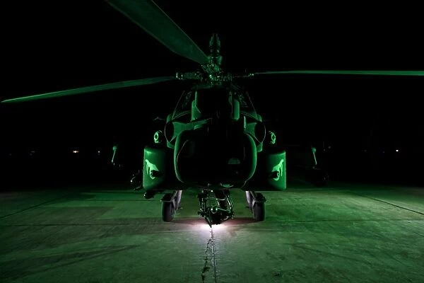 An AH-64D Apache helicopter at night