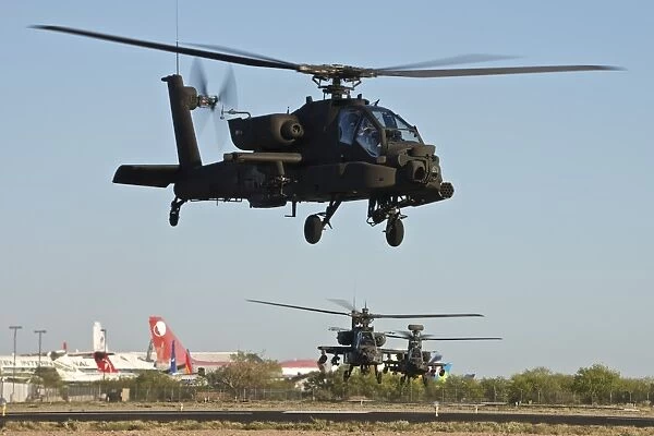 AH-64D Apache Longbow helicopters taking off on a mission