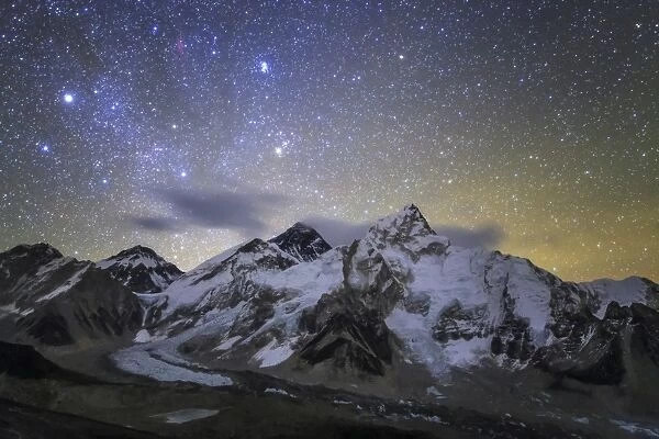 The bright stars of Auriga and Taurus rise above Mt. Everest and the central Himalayas