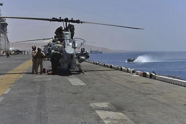 Captains perform pre-flight checks on an AH-1W Super Cobra