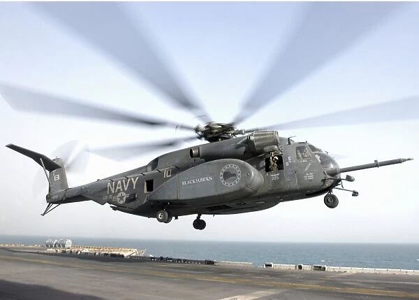 a CH-53 Sea Stallion helicopter leaves the flight deck of USS Kearsarge