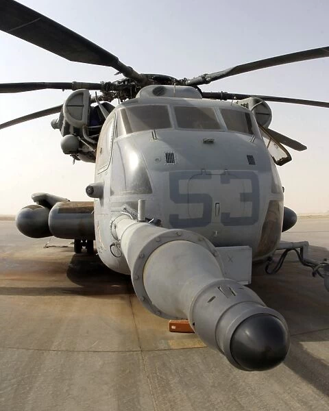 A CH-53E Super Stallion helicopter sitting on the flight line at Al Asad Air Base, Iraq
