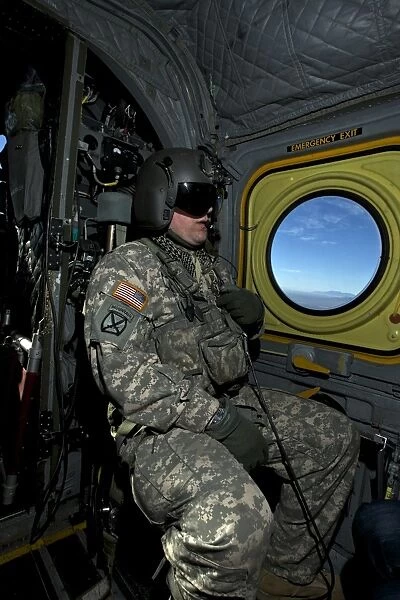 Crew chief looking out the window of a CH-47 Chinook