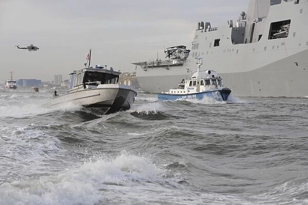 Crews from the coast guard and police departments escort USS New York as it sails