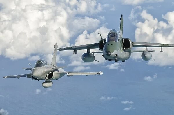 A Dassault Rafale of the French Air Force flys alongside an Embraer A-1B of the Brazilian