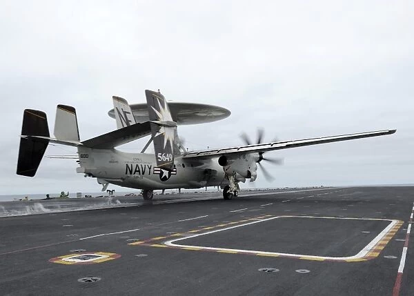 An E-2C Hawkeye launches off the flight deck of USS Abraham Lincoln